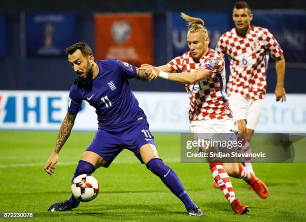 Kostas Mitroglou of Greece is challenged by Domagoj Vida of Croatia during the FIFA 2018 World Cup Qualifier Play-Off: First Leg between Croatia and...