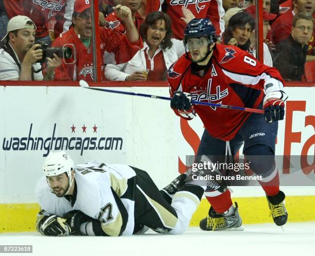 Alex Ovechkin of the Washington Capitals hits Craig Adams of the Pittsburgh Penguins during Game Seven of the Eastern Conference Semifinal Round of...