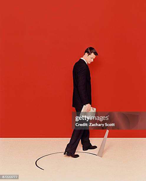 man averts saw cutting hole in ground below him - dodging stock pictures, royalty-free photos & images