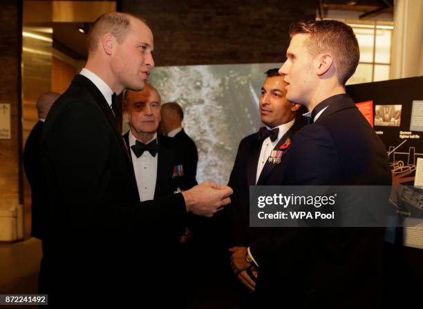 Britain's Prince William, Duke of Cambridge speaks to Luke Wigman, right, an RAF veteran, and former Army captain Ibrar Ali at the City Veterans...