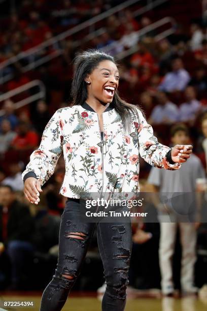 Olympic Gold Medalist Simone Biles reacts after a free throw attempt before the game between the Houston Rockets and the Utah Jazz at Toyota Center...