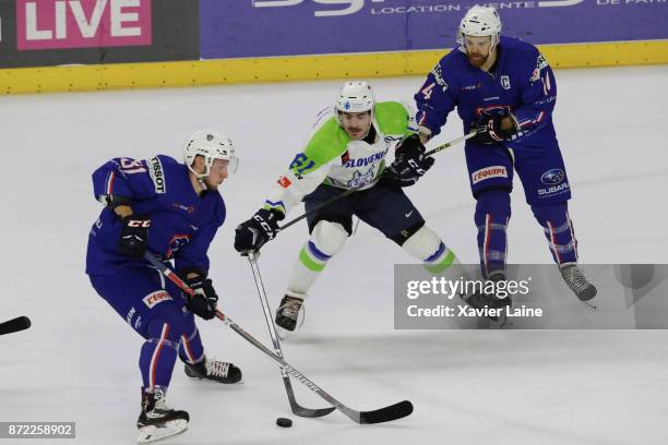 Anhony Rech of France in action with Stephane Da Costa and Jurij Repe of Slovenia during the EIHF Ice Hockey Four Nations tournament match between...