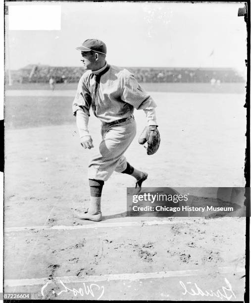 Informal full-length portrait of first baseman Charles Arnold 'Chick' Gandil of the American League's Washington Senators, following through after...