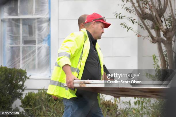 Workers carry away the bullet-scarred front door of the First Baptist Church of Sutherland Springs on November 9, 2017 in Sutherland Springs, Texas....