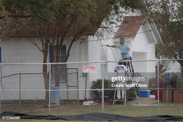 Workers patch bullet holes and paint the exterior of the First Baptist Church of Sutherland Springs on November 9, 2017 in Sutherland Springs, Texas....