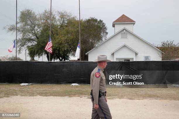 Police keep watch outside of the First Baptist Church of Sutherland Springs after it was surrounded by a tarp on November 9, 2017 in Sutherland...