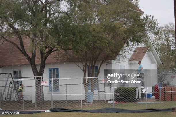 Workers patch bullet holes and paint the exterior of the First Baptist Church of Sutherland Springs on November 9, 2017 in Sutherland Springs, Texas....