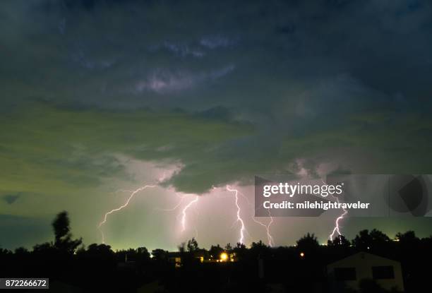 thunderhead lightning bolts strikes over denver colorado neighborhood homes - lightning home stock pictures, royalty-free photos & images