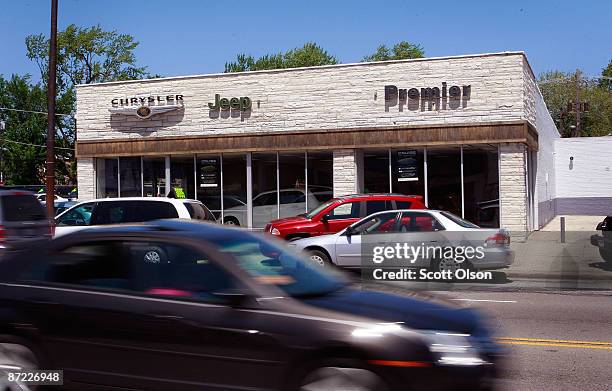 Traffic passes by Premier Chrysler May 14, 2009 in Chicago, Illinois. The dealership was one of 789 Chrysler dealerships nationwide that will be...