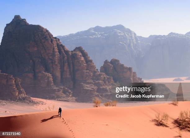 hiking through the desert in wadi rum - wadi rum stock pictures, royalty-free photos & images