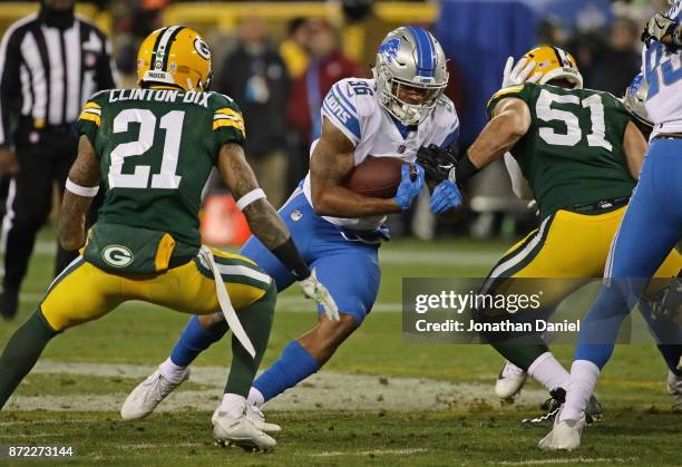 Dwayne Washington of the Detroit Lions runs between Ha Ha Clinton-Dix and Kyler Fackrell of the Green Bay Packers at Lambeau Field on September 28,...