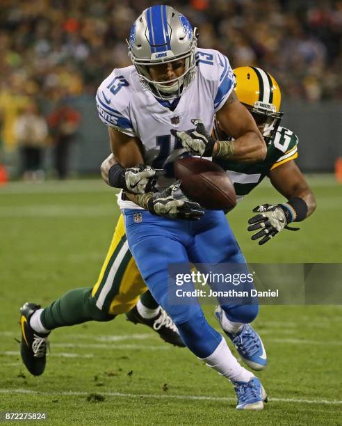 Jones of the Detroit Lions maintains control of the ball as he's hit by Marwin Evans of the Green Bay Packers at Lambeau Field on September 28, 2017...