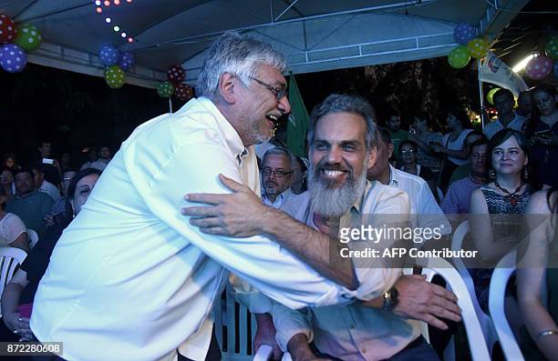 Former Paraguayan president Fernando Lugo and journalist Leonardo Rubin greet each other during the launch of their election campaign in Asuncion on...
