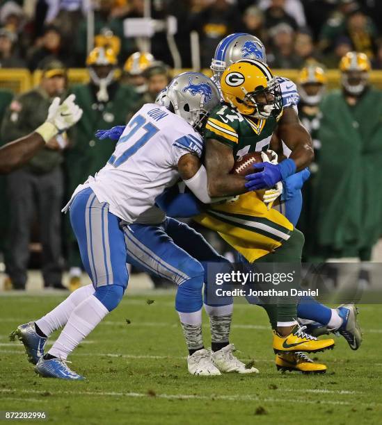 Davante Adams of the Green Bay Packers is stopped by Glover Quin and Tahir Whitehead of the Detroit Lions at Lambeau Field on September 28, 2017 in...