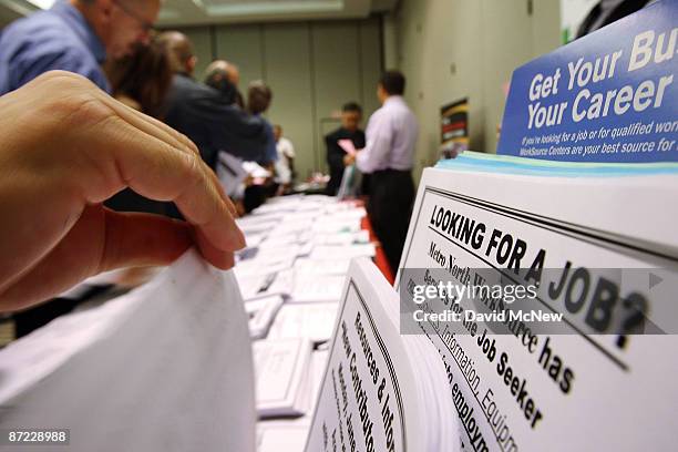 Job seekers look over job opening fliers at the WorkSource exhibit, a collaborative effort by governmental agencies to offer jobs and job training...