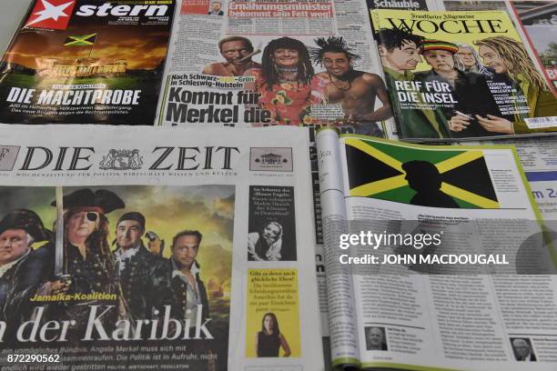 Picture taken on November 9, 2017 showing caricatures and altered photographs in German newspapers and magazines poking fun at the so-called "Jamaica...