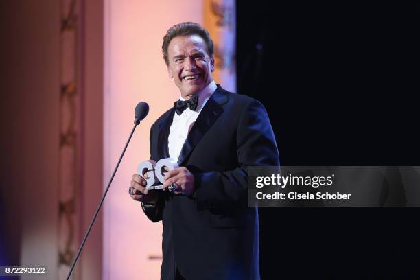 Legend of the Century" GQ Man of the year Arnold Schwarzenegger is seen on stage at the GQ Men of the year Award 2017 show at Komische Oper on...