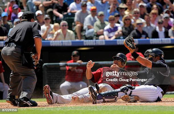 Carlos Lee of the Houston Astros is called out by homeplate umpire Charlie Redford as he slides into home and is tagged out by catcher Yorvit...