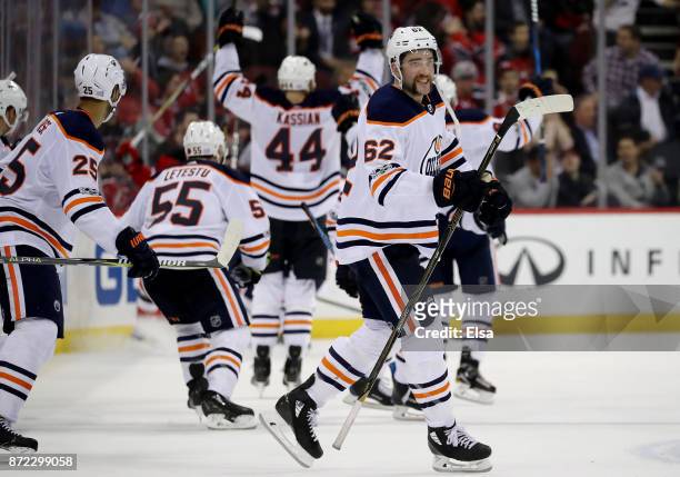 Eric Gryba of the Edmonton Oilers and the rest of the bench celebrates teammate Leon Draisaitl's game winning goal in overtime against the New Jersey...