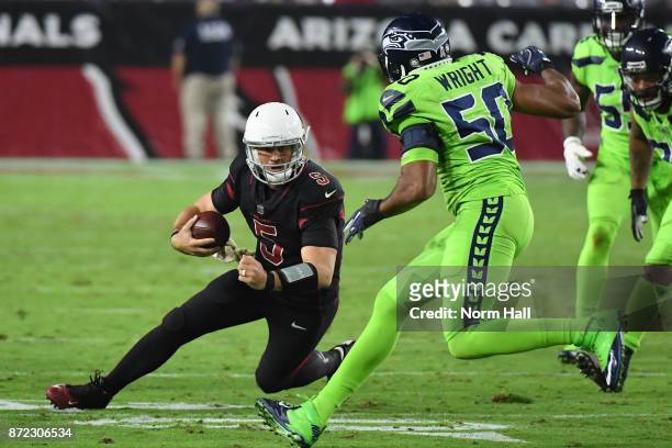 Quarterback Drew Stanton of the Arizona Cardinals scrambles with the football in front of outside linebacker K.J. Wright of the Seattle Seahawks in...