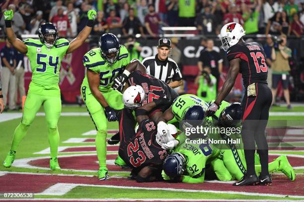 Defensive tackle Nazair Jones of the Seattle Seahawks tackles running back Adrian Peterson of the Arizona Cardinals in the end zone for a safety in...