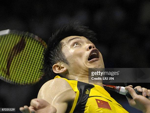 China's Lin Dan smashes a shuttlecock against Indonesia's Simon Santoso during the men's singles preliminary match at the Sudirman Cup World Team...