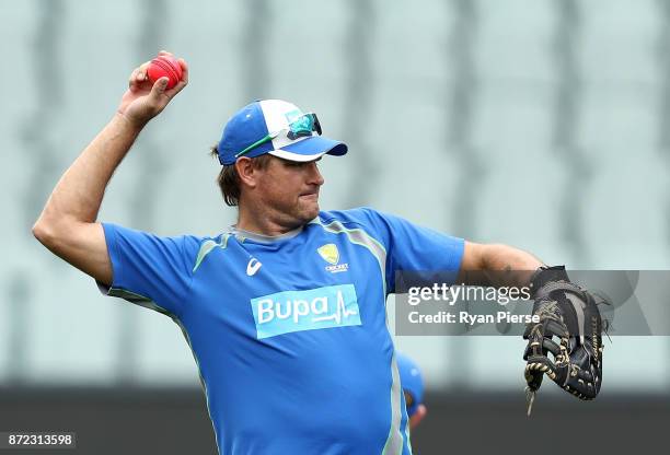 Head Coach of CA XI Ryan Harris throws during day three of the four day tour match between Cricket Australia XI and England at Adelaide Oval on...