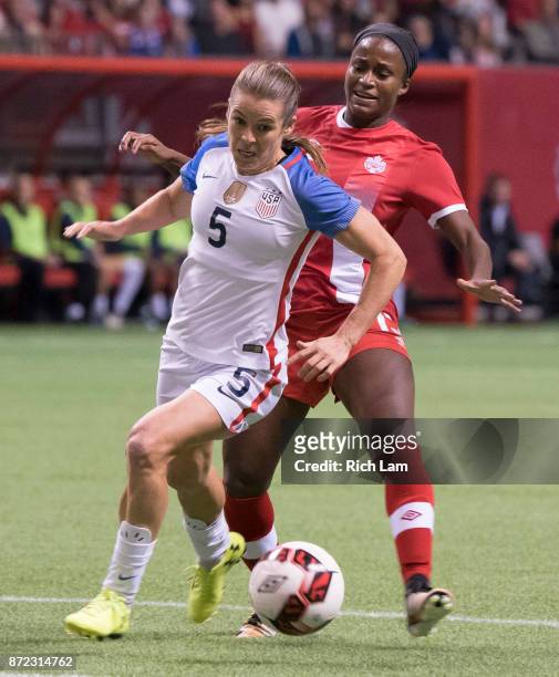 Nichelle Prince of Canada tries to take the ball away from Kelley O'Hara of the United States during International Friendly soccer match action at BC...
