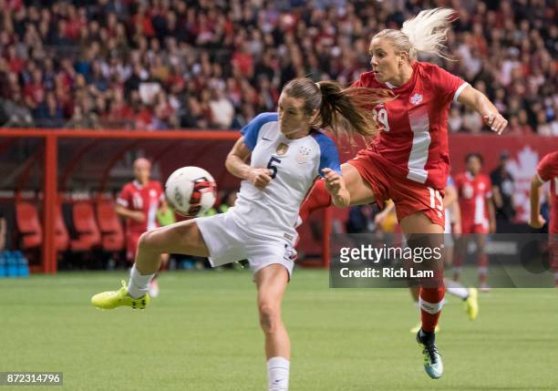 Adriana Leon of Canada kicks the ball past Kelley O'Hara of the United States while trying to get a shot on goal during International Friendly soccer...