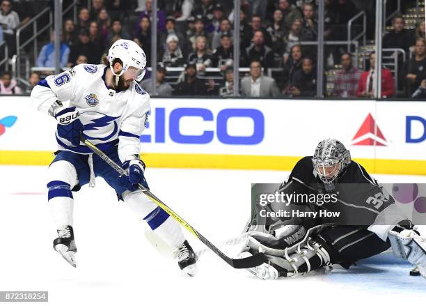 Nikita Kucherov of the Tampa Bay Lightning slides the puck under Jonathan Quick of the Los Angeles Kings to score and take a 1-0 lead during the...