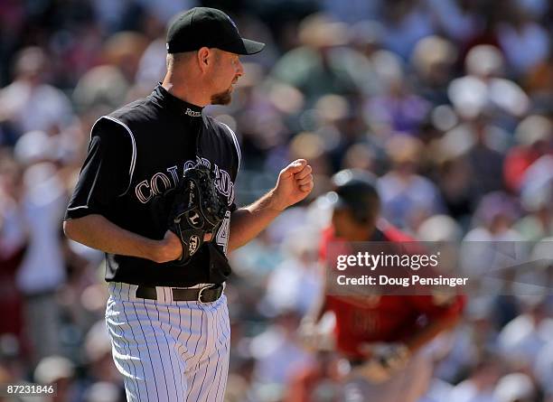 Relief pitcher Alan Embree of the Colorado Rockies returns to the mound after Carlos Lee of the Houston Astros rounds the bases after hitting a solo...