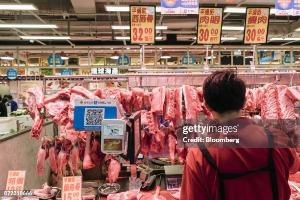 Merchant quick response code for Ant Financial Services Group's Alipay, an affiliate of Alibaba Group Holding Ltd., is displayed next to an Octopus...