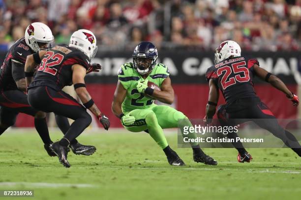 Running back C.J. Prosise of the Seattle Seahawks carries the football against free safety Tyrann Mathieu and defensive back Tramon Williams of the...