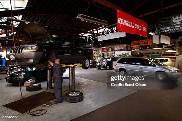 Juan Espinoza works on a Jeep in the service department at the Balzekas Chrysler dealership May 14, 2009 in Chicago, Illinois. The dealership, which...