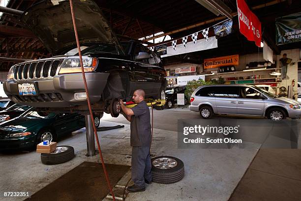 Juan Espinoza works on a Jeep in the service department at the Balzekas Chrysler dealership May 14, 2009 in Chicago, Illinois. The dealership, which...