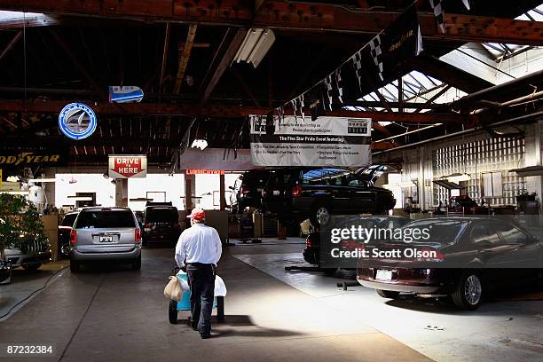 An ice cream vendor passes through the service department at the Balzekas Chrysler dealership May 14, 2009 in Chicago, Illinois. The dealership,...
