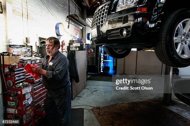 Larry Noga works on a vehicle in the service department at the Balzekas Chrysler dealership May 14, 2009 in Chicago, Illinois. The dealership, which...