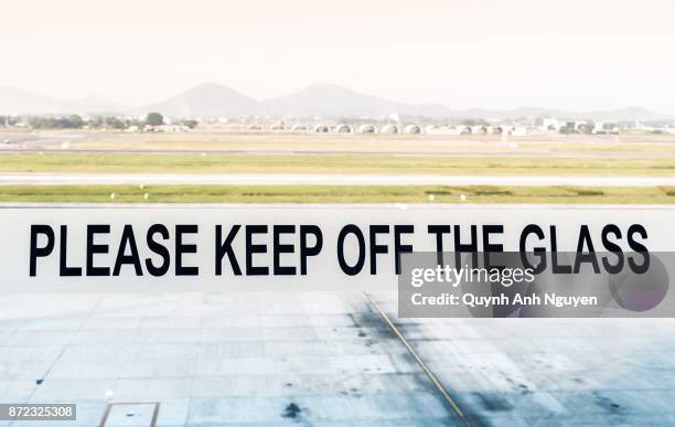 please keep off the glass - hanoi airport stock pictures, royalty-free photos & images