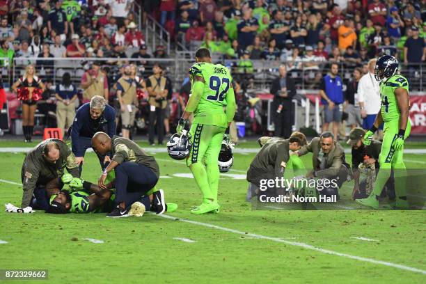 Defensive end Frank Clark and defensive tackle Sheldon Richardson of the Seattle Seahawks both lay on the field after a play in the second half of...