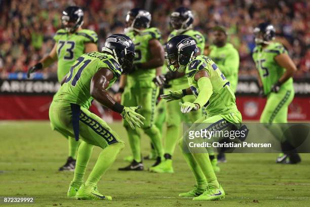 Strong safety Kam Chancellor and defensive back Bradley McDougald of the Seattle Seahawks celebrate a turnover on downs against the Arizona Cardinals...