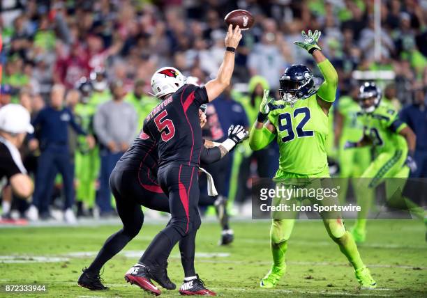 Arizona Cardinals quarterback Drew Stanton passes under pressure from Seattle Seahawks defensive tackle Nazair Jones during the NFL football game...