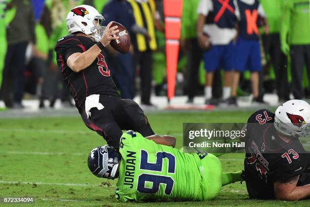 Quarterback Drew Stanton of the Arizona Cardinals is sacked by defensive end Dion Jordan of the Seattle Seahawks in the second half at University of...