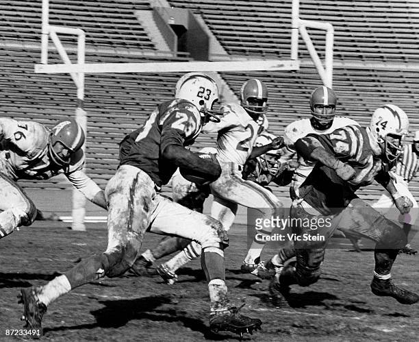 Half back Paul Lowe and offensive tackle Ron Mix of the Los Angeles Chargers run upfield in a 21 to 24 win over the Houston Oilers on November 13,...