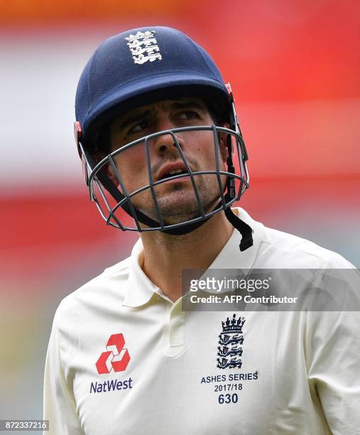 England's batsman Alastair Cook walks back to pavilion following his dismissal off Cricket Australia XI Simon Milenko on the third day of a four-day...