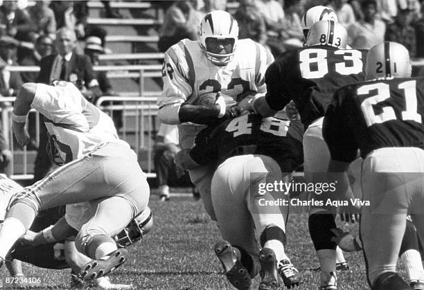 San Diego Chargers halfback Paul Lowe gets hit by Oakland Raiders linebacker Bill Budness during a 29-20 Chargers victory on September 25 at Oakland...