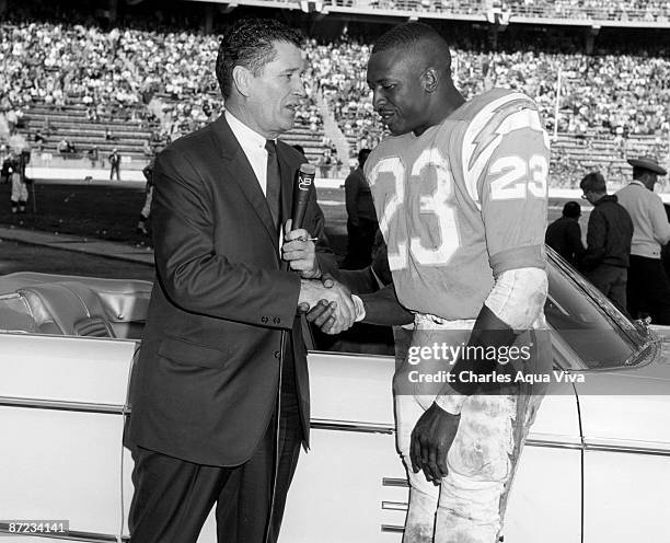 San Diego Chargers running back Paul Lowe receives congratulations and a new car from AFL Commissioner Joe Foss for being named AFL Player of the...