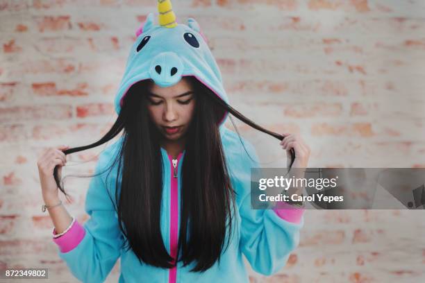 portrait of young brunette in unicorn  hooded onesie - ot coruña fotografías e imágenes de stock