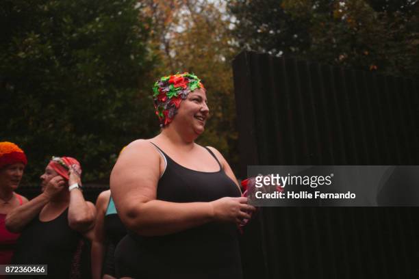 wild swimming women's group autumnal swim - fat old lady stock pictures, royalty-free photos & images