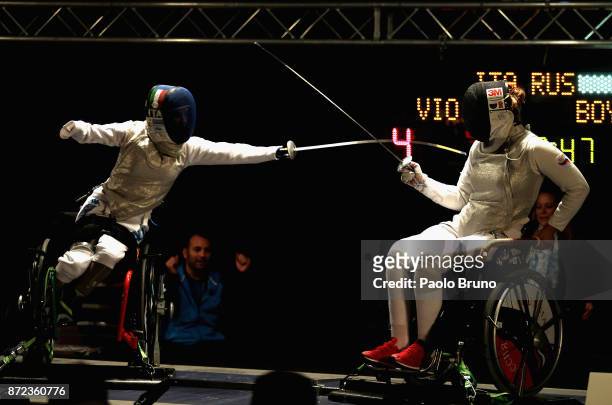 Beatrice Vio of Italy competes with Victoria Boykova of Russia in the Women's Final match foil fencing during the IWAS Wheelchair Fencing World...