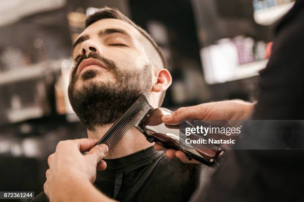 man getting his beard trimmed with electric razor - barbear imagens e fotografias de stock